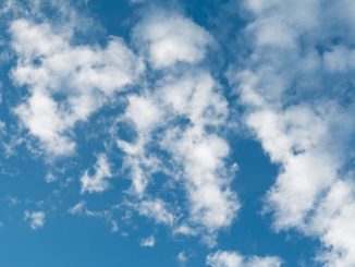 Ciel bleu parsemé de fins nuages blancs, durant le jour.