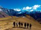 Groupe de personnes marchant dans les montagnes pendant la journée.