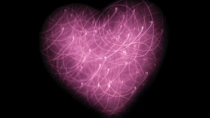 Large multicolored pink heart (need hearts) on a black background.