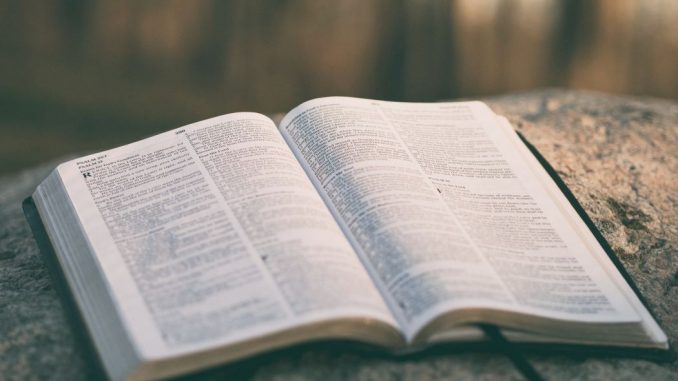 Open Bible on table top. A little blurry image.