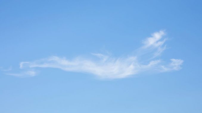 Blue sky with a thin white cloud in the center.